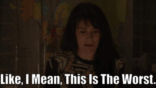 A Woman Says " Like I Mean This Is The Worst " In A Dark Room GIF