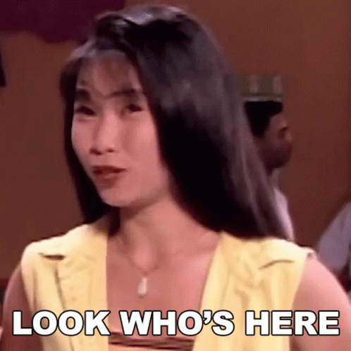 A Woman Says Look Who 'S Here While Looking At The Camera GIF