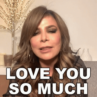 A Woman Says " Love You So Much " In Front Of A Vase GIF