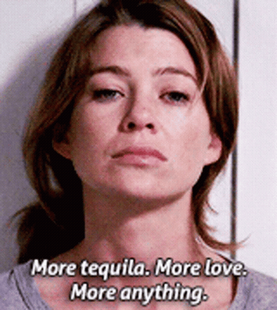 A Woman Says " More Tequila More Love More Anything " In Front Of A White Wall GIF