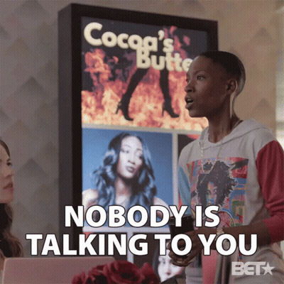 A Woman Says Nobody Is Talking To You In Front Of A Cocoa 'S Butter Sign GIF