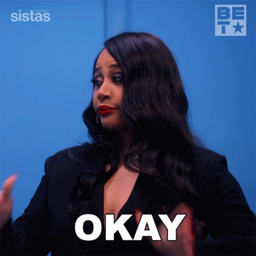 A Woman Says Okay With Her Hands Up GIF