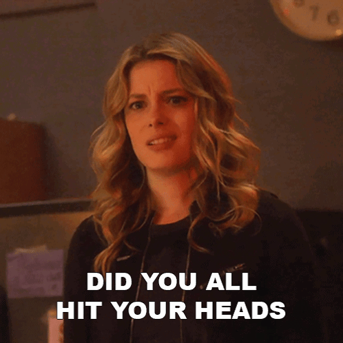 A Woman Says On Each Other 'S Heads While Looking At The Camera GIF