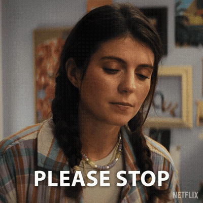 A Woman Says Please Stop In Front Of A Netflix Sign GIF