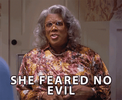 A Woman Says She Feared No Evil While Wearing Glasses And A Floral Shirt GIF