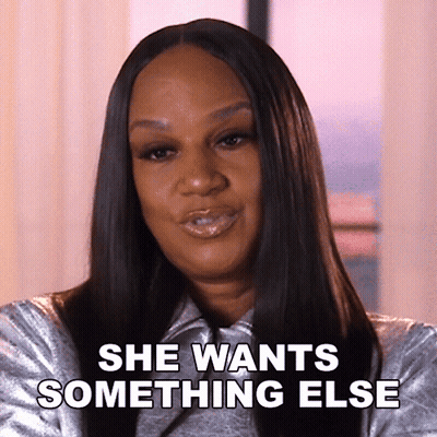 A Woman Says She Wants Something Else While Wearing A Silver Jacket . GIF