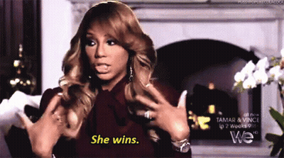 A Woman Says She Wins In Front Of A Fireplace . GIF