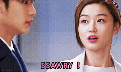 A Woman Says Ssawry While Looking At A Man In A Suit GIF