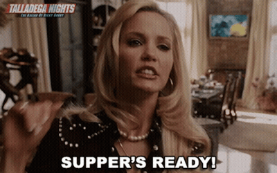 A Woman Says " Supper 'S Ready " In Front Of A Sign For Talladega Nights GIF