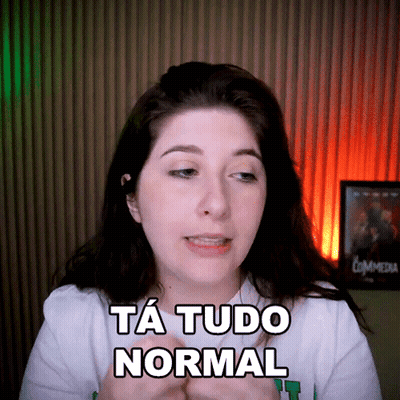 A Woman Says Ta Tudo Normal In Front Of A Commedia Poster GIF