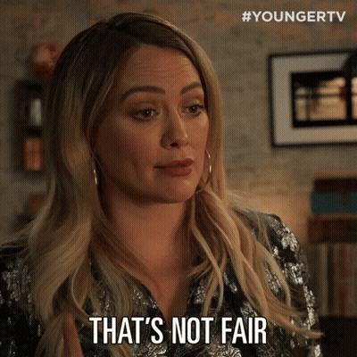 A Woman Says " That 'S Not Fair " While Wearing A Sequined Shirt GIF