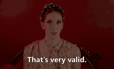A Woman Says That 'S Very Valid In Front Of A Red Wall GIF