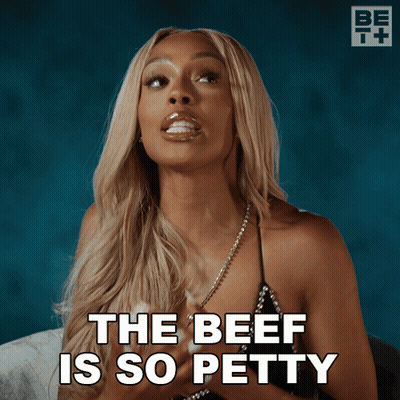 A Woman Says " The Beef Is So Petty " In Front Of A Blue Background GIF