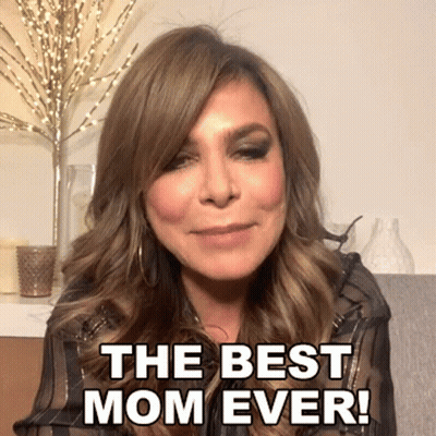 A Woman Says " The Best Mom Ever " In Front Of A Vase Of Candles GIF