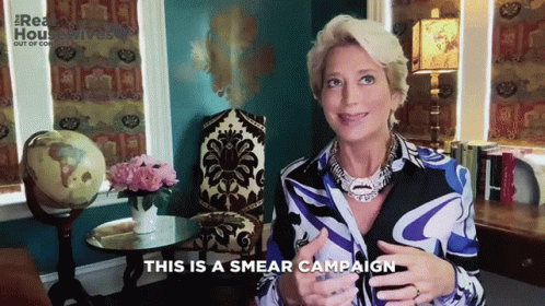 A Woman Says This Is A Smear Campaign In Front Of A Chair GIF