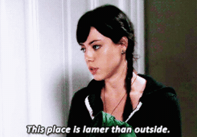 A Woman Says " This Place Is Lamer Than Outside " In Front Of A Wall GIF