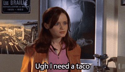 A Woman Says Ugh I Need A Taco In Front Of A Sign For Liz Braille GIF