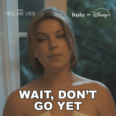 A Woman Says " Wait Don 'T Go Yet " In Front Of A Hulu Logo GIF