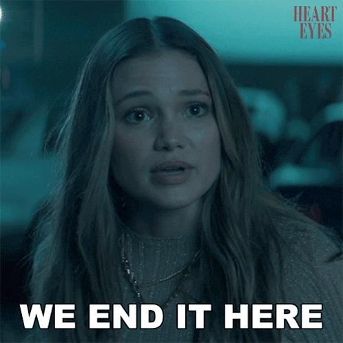 A Woman Says " We End It Here " In Front Of A Heart Eyes Poster GIF