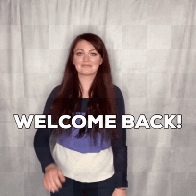 A Woman Says Welcome Back In Front Of A White Background GIF