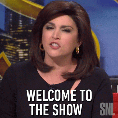 A Woman Says Welcome To The Show On A Snl Sign GIF