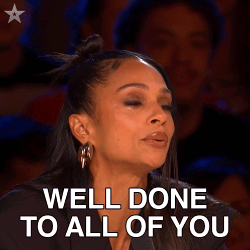 A Woman Says Well Done To All Of You In A Crowded Room GIF