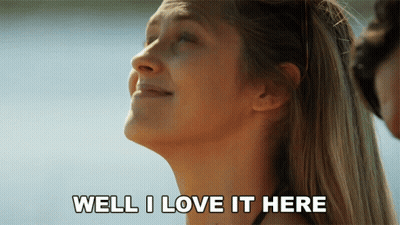 A Woman Says Well I Love It Here In Front Of A Body Of Water GIF