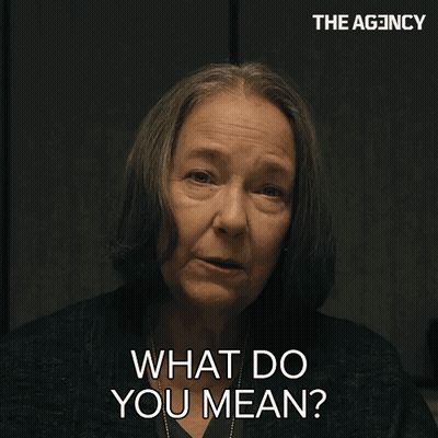 A Woman Says " What Do You Mean " In Front Of A Sign That Says The Agency GIF