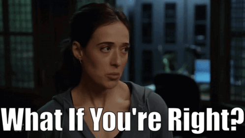 A Woman Says " What If You 'Re Right " In A Dark Room GIF
