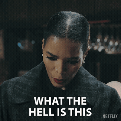 A Woman Says What The Hell Is This With A Netflix Logo Behind Her GIF