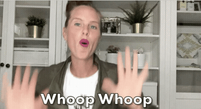 A Woman Says Whoop Whoop In Front Of A Bookshelf GIF