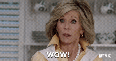A Woman Says Wow In Front Of A Netflix Ad GIF