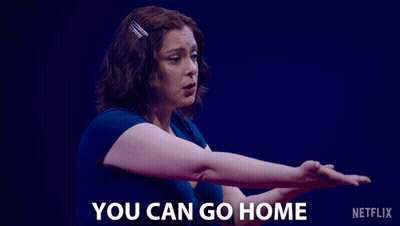 A Woman Says " You Can Go Home " In Front Of A Blue Background GIF