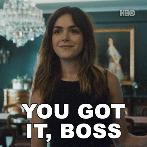 A Woman Says You Got It Boss In Front Of A Painting GIF