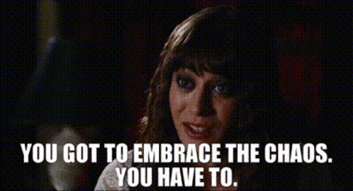 A Woman Says " You Got To Embrace The Chaos You Have To " In A Dark Room GIF