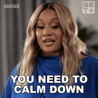 A Woman Says You Need To Calm Down In A Blue Shirt GIF