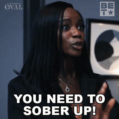 A Woman Says " You Need To Sober Up " In Front Of A Framed Picture GIF