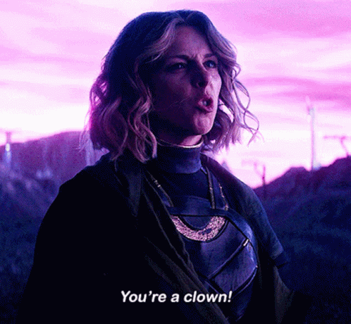 A Woman Says " You 'Re A Clown " While Standing In A Field GIF