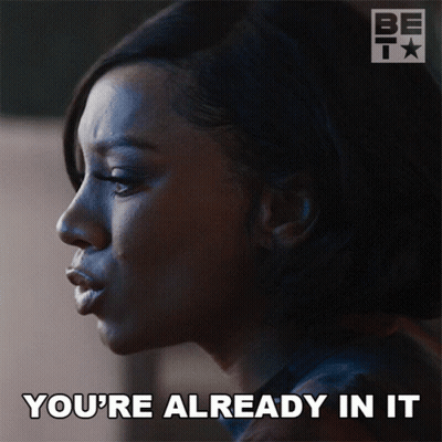 A Woman Says " You 'Re Already In It " In Front Of A Bet Logo GIF