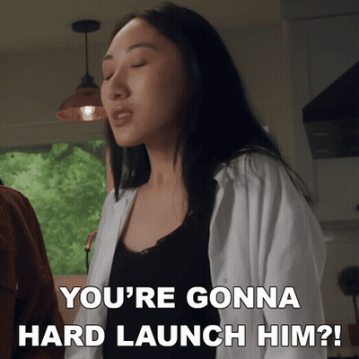 A Woman Says " You 'Re Gonna Hard Launch Him " In A Kitchen GIF
