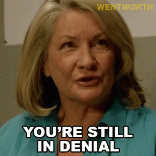 A Woman Says " You 'Re Still In Denial " In A Blue Shirt GIF