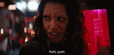 A Woman Says Yum Yum In Front Of A Pink Container GIF