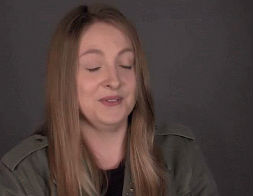 A Woman Scratching Her Head With A Bracelet That Says No 2 On Her Wrist GIF