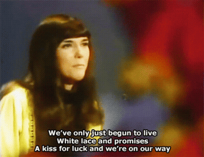 A Woman Singing A Song That Says We 'Ve Only Just Begun To Live GIF