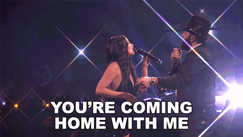 A Woman Singing Into A Microphone Next To A Man With The Words " You 'Re Coming Home With Me " On The Bottom GIF