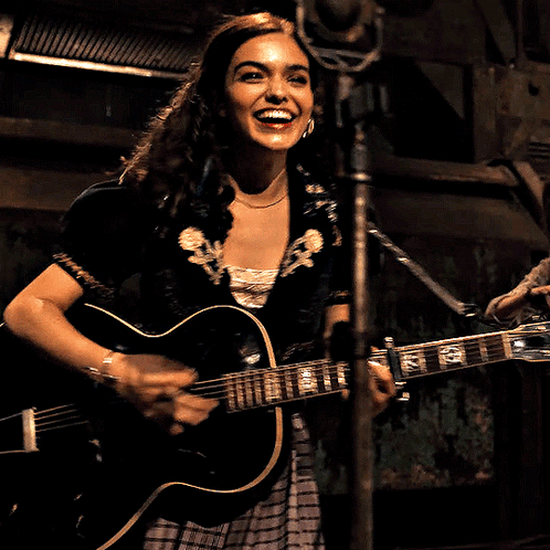 Woman Singing Into Microphone Holding G Guitar GIF