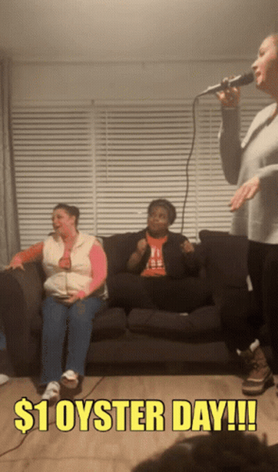 A Woman Singing Into A Microphone With $ 1 Oyster Day Written On The Bottom GIF