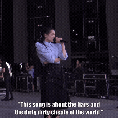 A Woman Singing Into A Microphone With A Caption That Says This Song Is About The Liars GIF