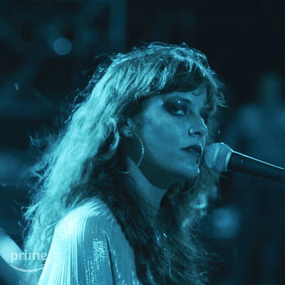 A Woman Singing Into A Microphone With A Prime Logo In The Corner GIF