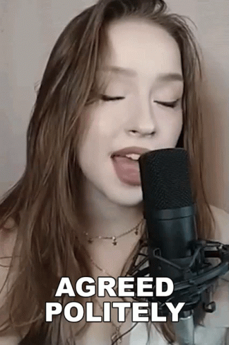 A Woman Singing Into A Microphone With Her Tongue Out And The Words Agreed Politely Above Her GIF